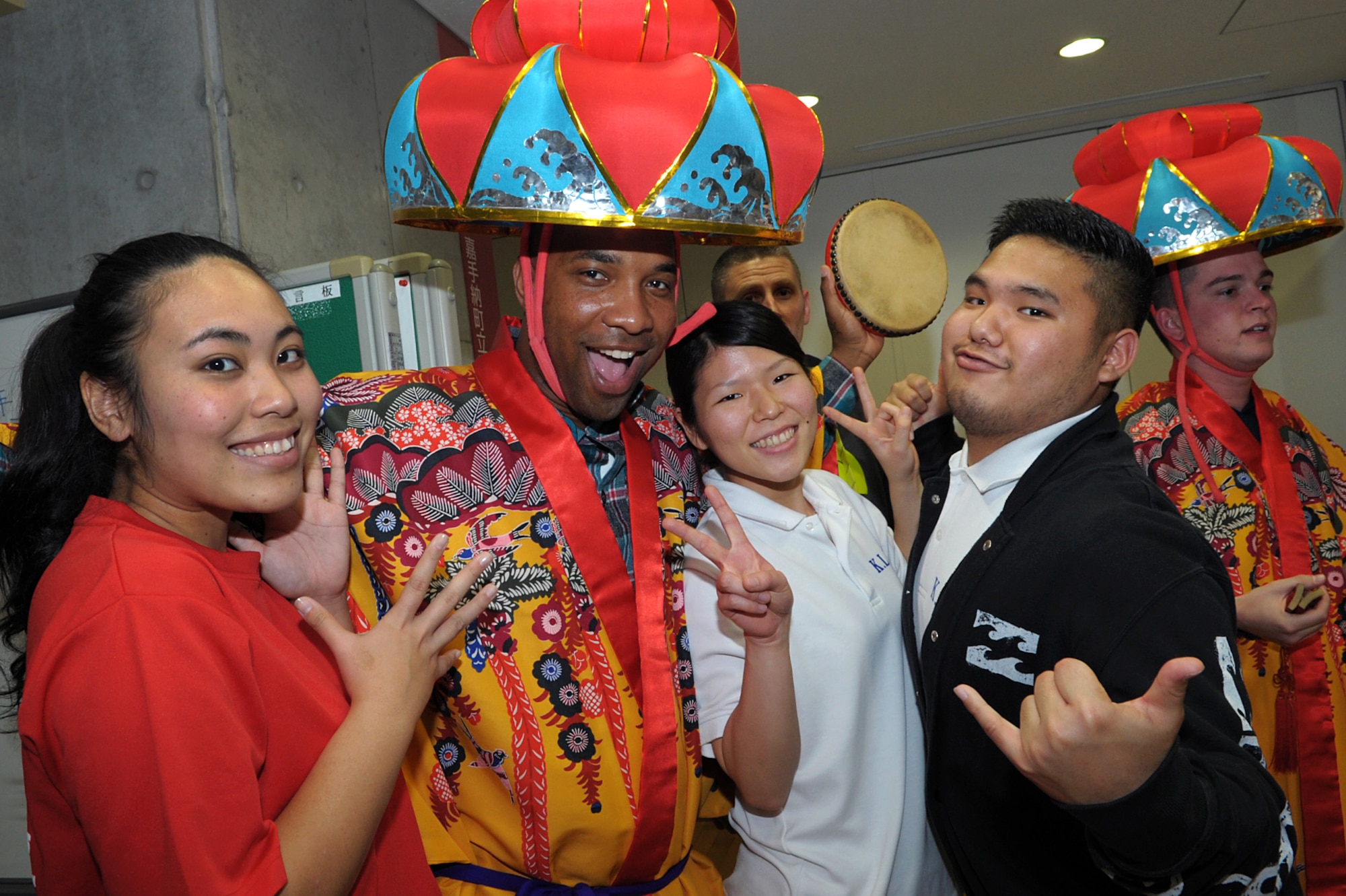 U.S. Air Force Master Sgt. Chris Pearsall (center), 18th Logistic Readiness Squadron petroleum, oils and lubricants quality assurance evaluator, poses with students at the Kadena Language Institute on Okinawa, Japan, while volunteering to help them practice English on Jan. 16, 2015. Pearsall has dedicated hundreds of volunteer hours in the off-base community since arriving in Okinawa in 2012. (U.S. Air Force photo by Tim Flack)