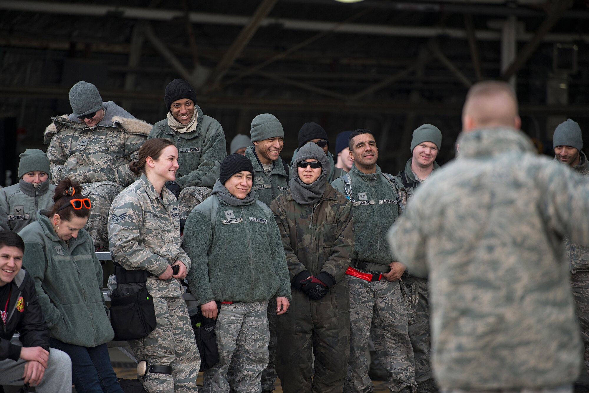 Several audience members laugh at a joke told by Col. Brook Leonard, 51st Fighter Wing commander, after a quarterly load crew competition Feb. 6, 2015, at Osan Air Base, Republic of Korea. Leonard talked about the importance of mission readiness and how load crew competitions are one of the most important elements of Team Osan's mission. "This is for pride and bragging rights, but it's also why we're here," he said. 