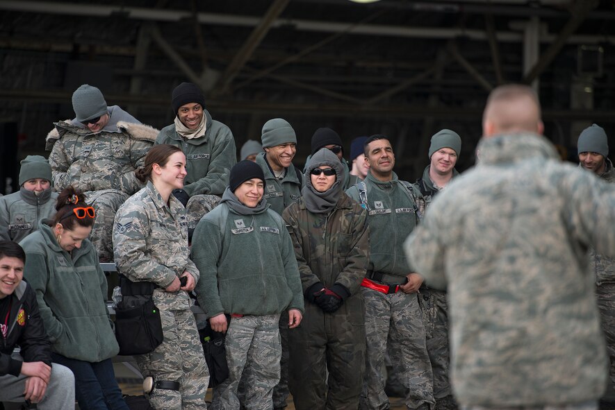 Several audience members laugh at a joke told by Col. Brook Leonard, 51st Fighter Wing commander, after a quarterly load crew competition Feb. 6, 2015, at Osan Air Base, Republic of Korea. Leonard talked about the importance of mission readiness and how load crew competitions are one of the most important elements of Team Osan's mission. "This is for pride and bragging rights, but it's also why we're here," he said. 