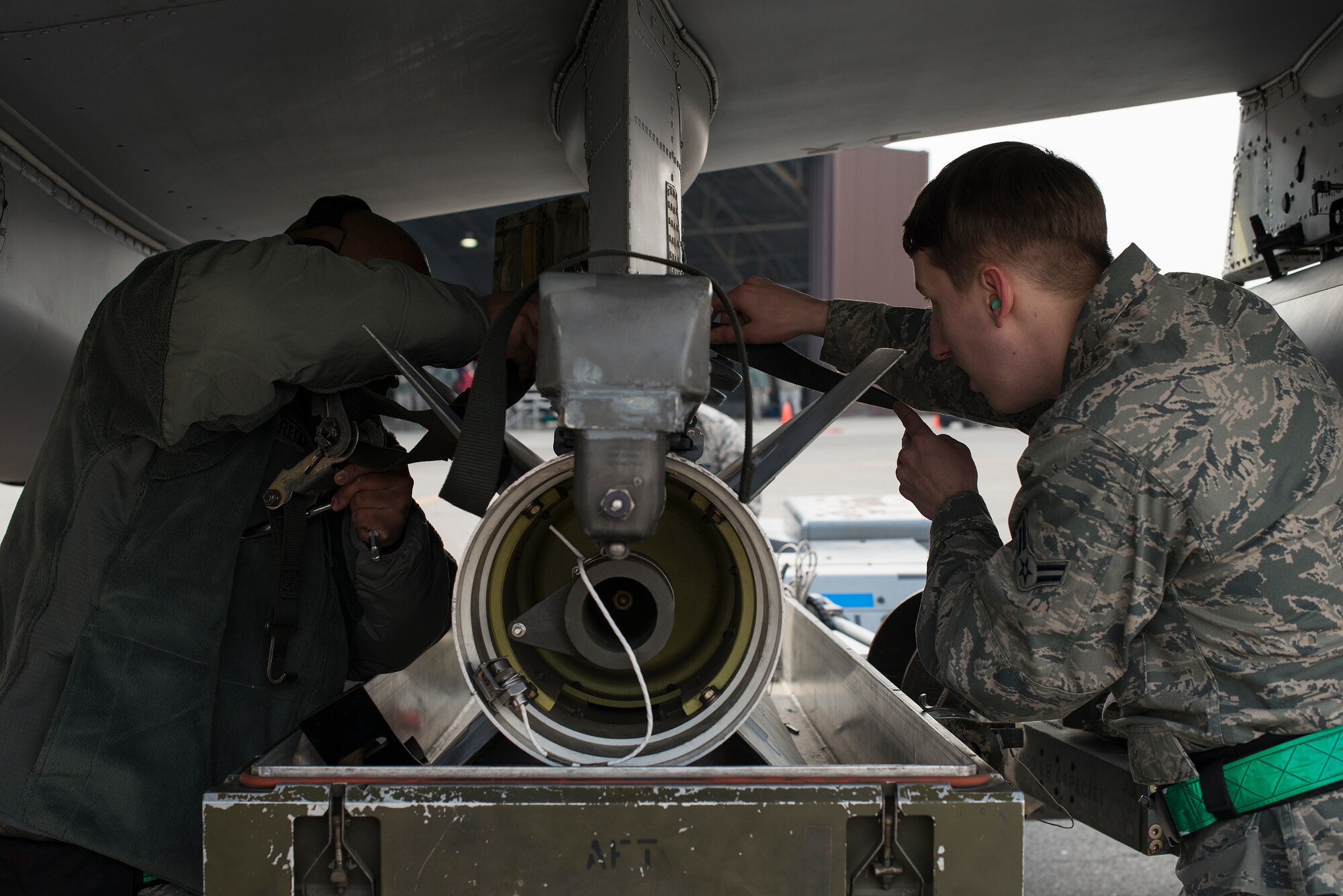Members of the 25th Aircraft Maintenance Unit weapons load crew team put a missile into place on an A-10 during a quarterly load crew competition Feb. 6, 2015, at Osan Air Base, Republic of Korea. The competition had a time limit of 34-minutes, but each team finished early. (U.S. Air Force photo by Staff Sgt. Jake Barreiro)