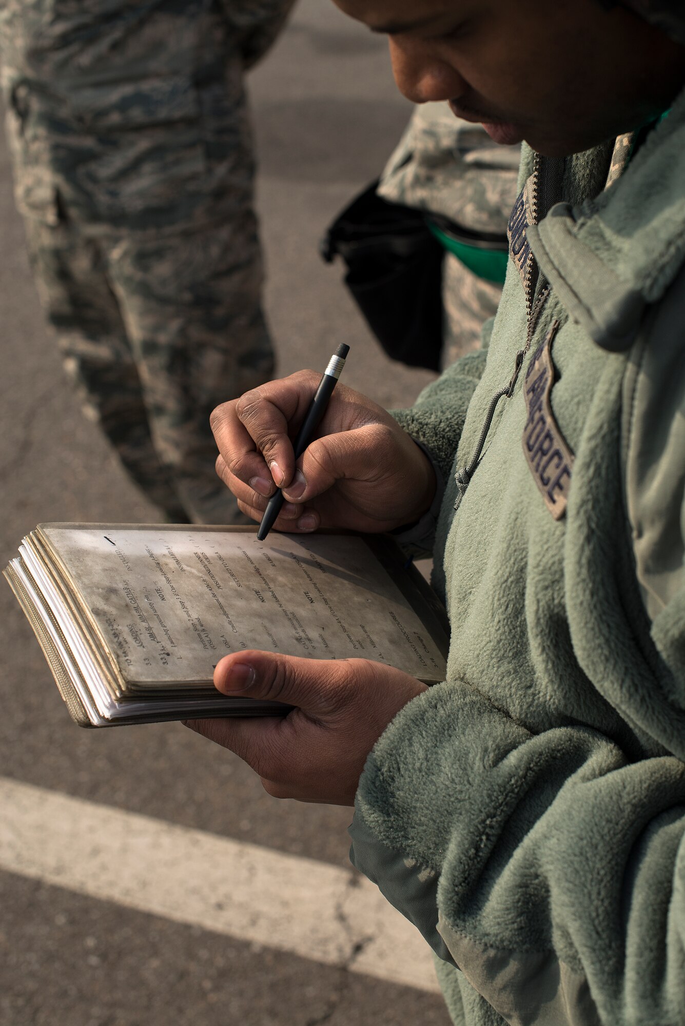 Members of the 25th Aircraft Maintenance Unit weapons load crew team examine items on their checklist before completing the contest during a quarterly load crew competition Feb. 6, 2015, at Osan Air Base, Republic of Korea. The competition is meant not only to test abilities, but to promote teamwork, camaraderie and a healthy rivalry among the units. (U.S. Air Force photo by Staff Sgt. Jake Barreiro)
