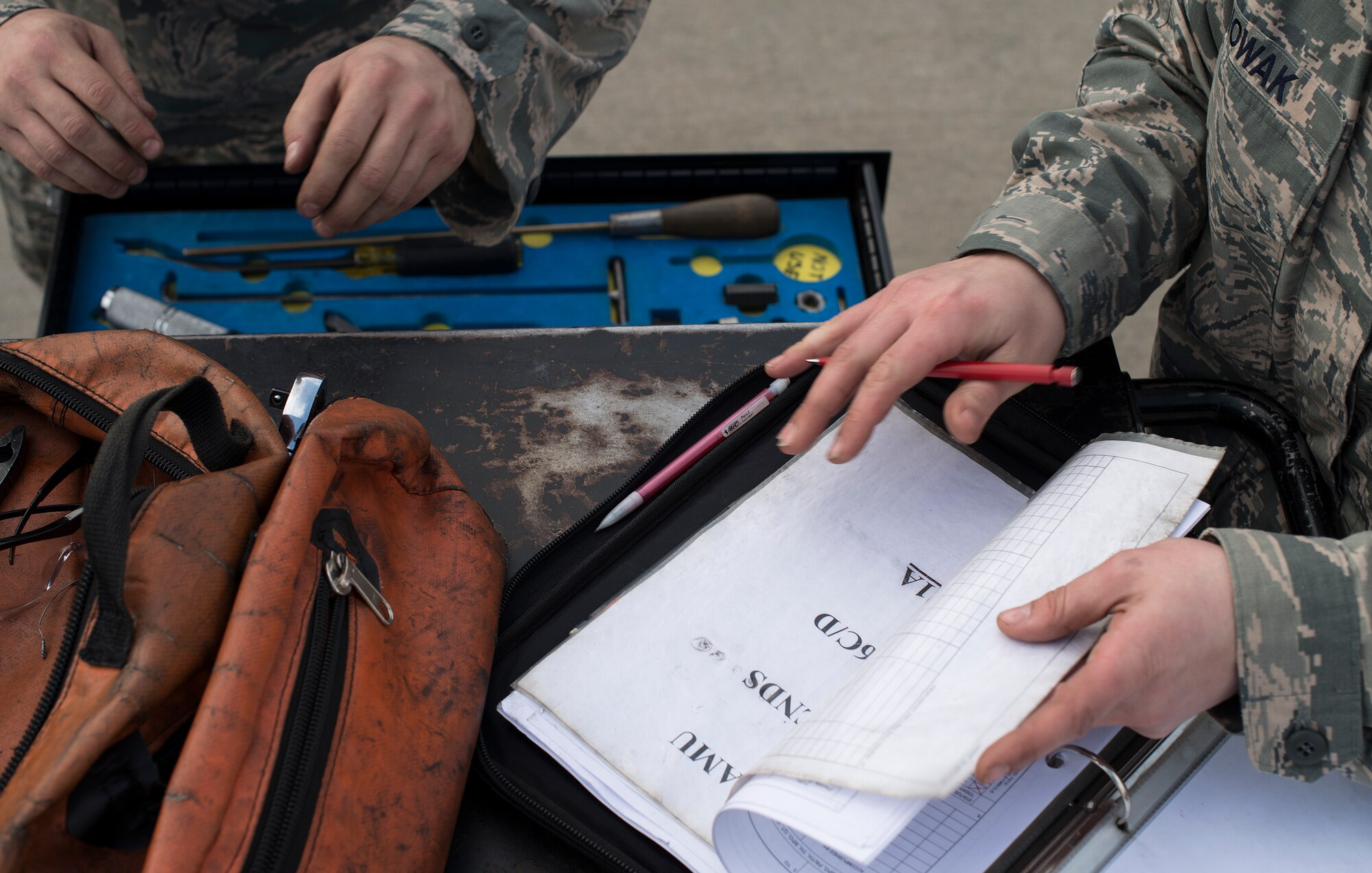Members of the 36th Aircraft Maintenance Unit weapons load crew team examine items on their checklist before completing the contest during a quarterly load crew competition Feb. 6, 2015, at Osan Air Base, Republic of Korea. The 25th and 36th AMUs routinely go head-to-head in this competition, with the winner assuming the title of best load crew on Osan. (U.S. Air Force photo by Staff Sgt. Jake Barreiro)