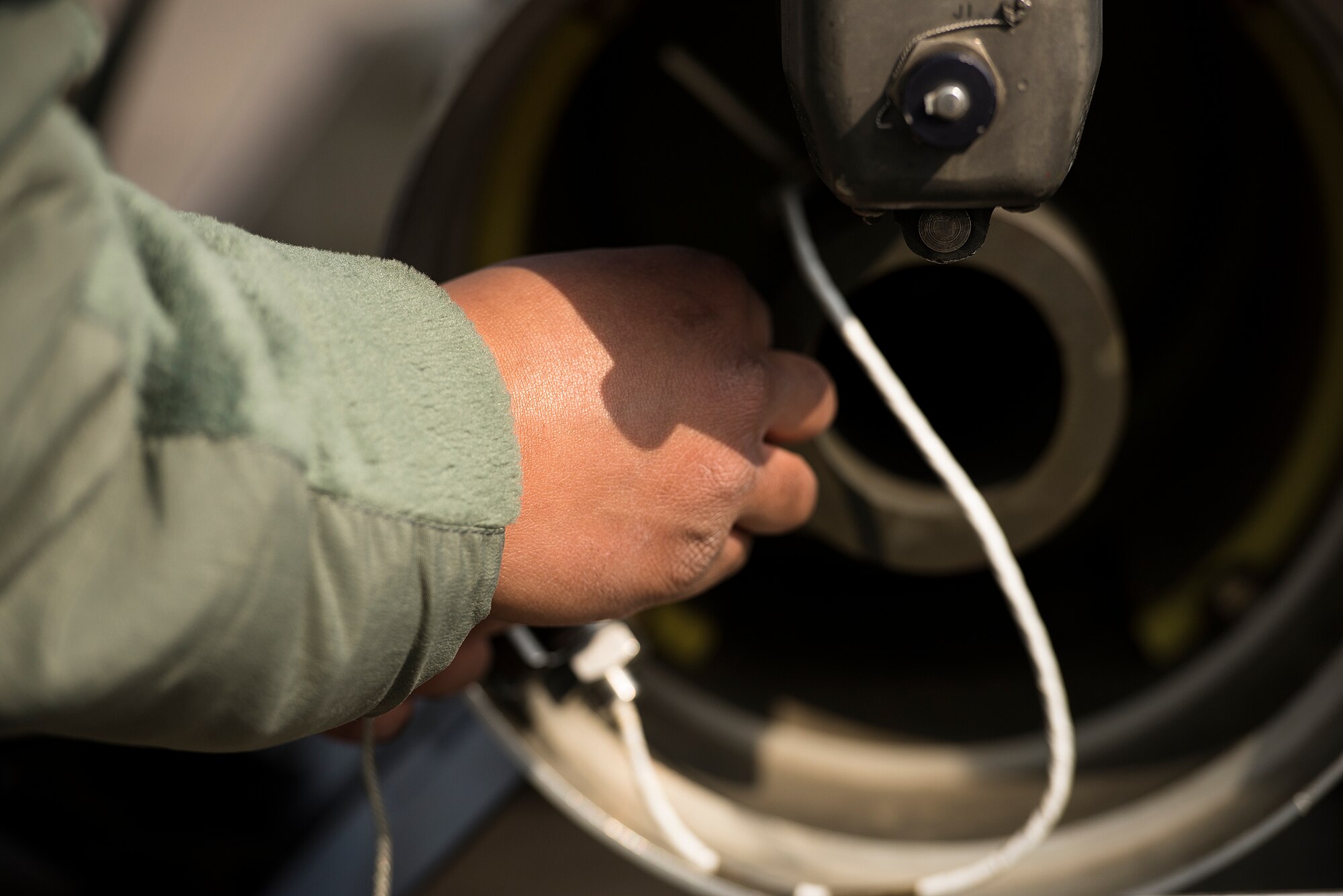 A member of the 25th Aircraft Maintenance Unit weapons load crew team works on an A-10 during a quarterly load crew competition Feb. 6, 2015, at Osan Air Base, Republic of Korea. Proper weapons loading is pivotal to ensure the base's A-10 and F-16s can be properly ready to respond to an emergency, a key element in preserving stability, a major principle of Osan AB. (U.S. Air Force photo by Staff Sgt. Jake Barreiro)