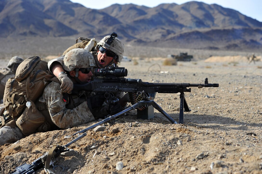 Marines fire their M240 machine gun while covering an advance on an objective at a training event during Integrated Training Exercise 2-15 at the Marine Corps Air Ground Combat Center in Twentynine Palms, Calif., Feb. 1, 2015.
