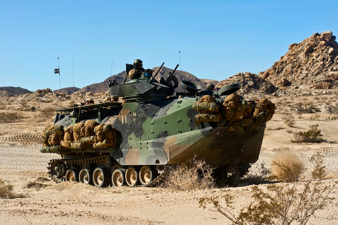 Marines maneuver towards their objective in an armored amphibious vehicle while participating in a mechanized assault course during Integrated Training Exercise 2-15 at the Marine Corps Air Ground Combat Center in Twentynine Palms, Calif., Feb. 4, 2015.