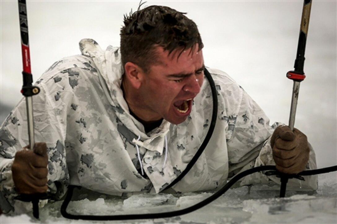 Marine Corps Staff Sgt. John Freeseha begins singing the Marines' Hymn after completing a plunge into freezing water during an ice-breaker drill as part of Winter Mountain Leaders Course 1-15 at Levitt Lake on Marine Corps Mountain Warfare Training Center in Bridgeport, Calif., Jan. 30, 2015. 
