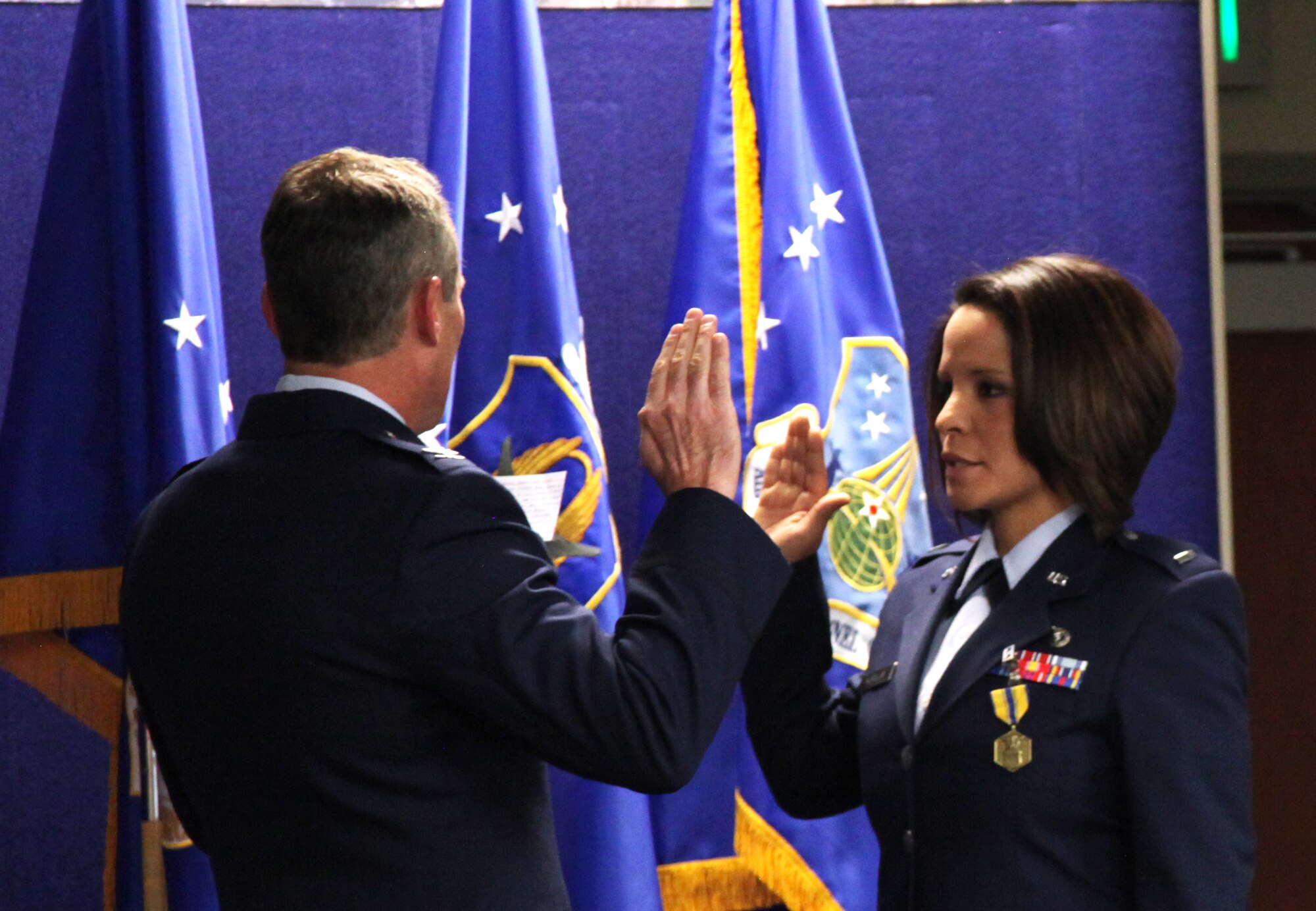 1st Lt. Iris Morales, Medical Service Corps officer and former Air Reserve Personnel Center contact center noncommissioned officer, is administered the Oath of Office by Col. Pat Hayes, ARPC Total Force Service Center director, during a commissioning ceremony held Jan. 30, 2015, on Buckley Air Force Base, Colo. (U.S. Air Force photo/Tech. Sgt. Rob Hazelett)