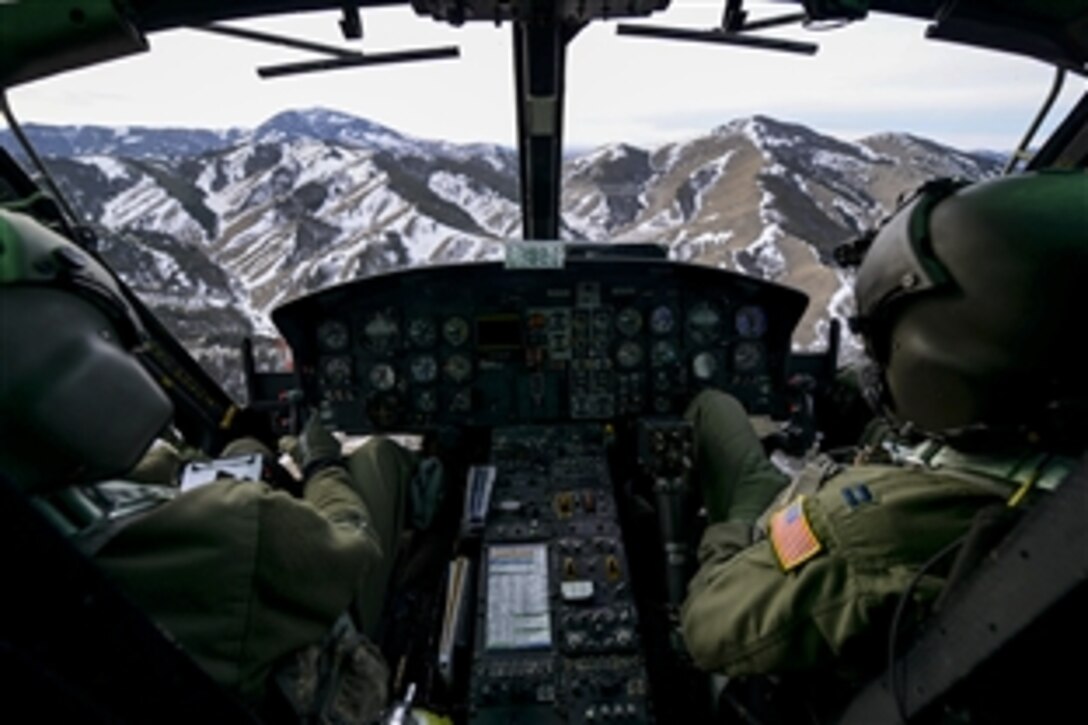 Air Force 1st Lt. Greg Johnston, left, and Capt. RJ Bergman fly a UH-1N Iroquois over a mountain range near Malmstrom Air Force Base in Great Falls, Mont., Jan. 27, 2015. Johnston and Bergman are assigned to the 40th Helicopter Squadron. 
