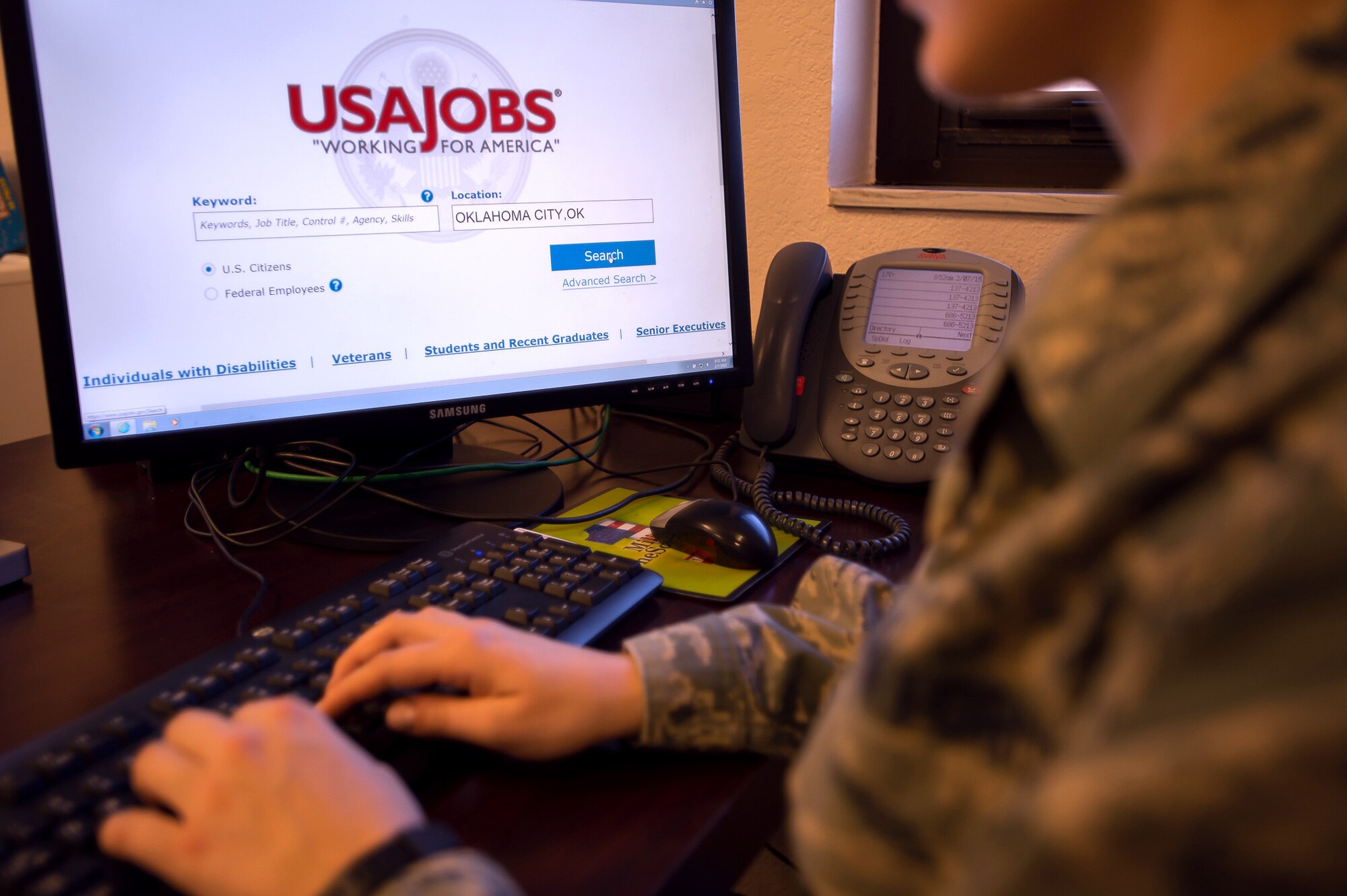 A member of the 137th Air Refueling Wing looks up federal jobs on the USAJobs website. (U.S. Air National Guard photo by Airman 1st Class Tyler Woodward/Released)