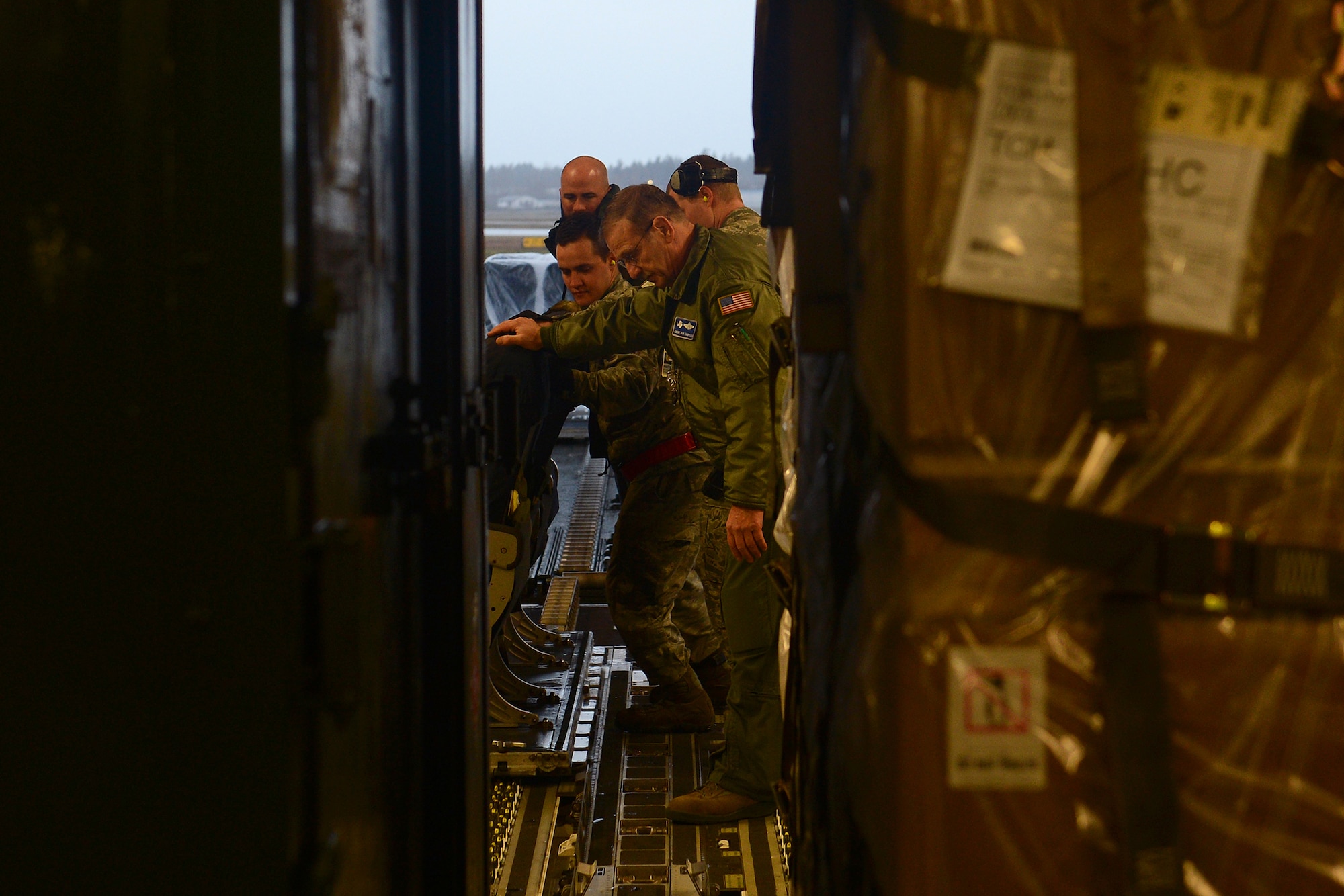 Airmen from the 62nd and 446th Airlift Wings load cargo into a C-17 Globemaster Feb. 7, 2015 at Joint Base Lewis-McChord, Wash., in support of Operation Deep Freeze. Operation Deep Freeze will deliver supplies and pick up personnel from Antarctica for the National Science Foundation. (U.S. Air Force photo\ Staff Sgt. Tim Chacon)