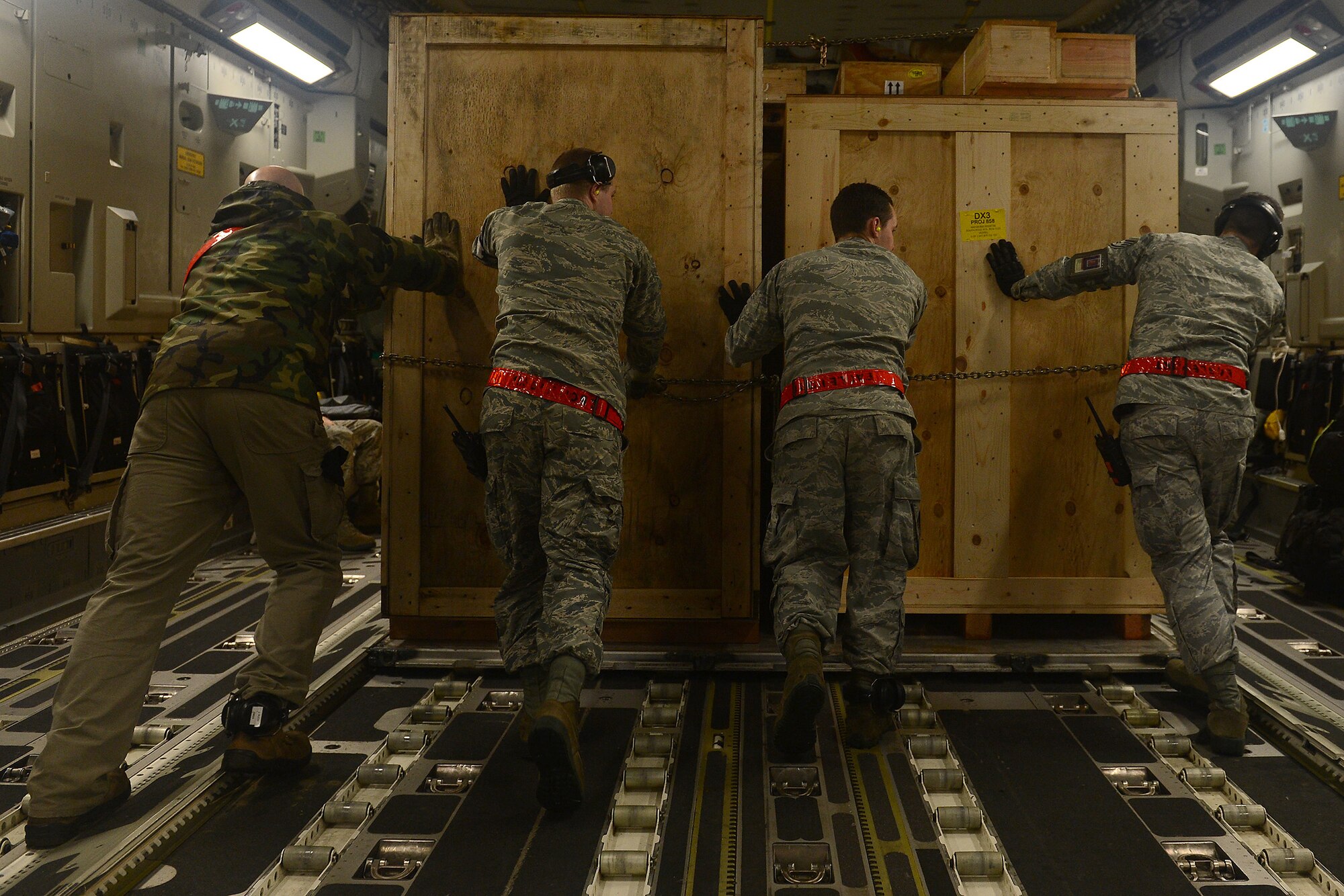 Airmen from the 62nd Airlift Squadron load cargo into a C-17 Globemaster Feb. 7, 2015 at Joint Base Lewis-McChord, Wash., in support of Operation Deep Freeze. This mission marks the 575th mission McChord Airmen have supported the National Science Foundation’s work in Antarctica. (U.S. Air Force photo\ Staff Sgt. Tim Chacon) 