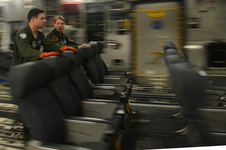 Senior Airman Shelby Conry(background), 10th Airlift Squadron loadmaster, and Staff Sgt. Ryan Anderson,62nd Operations Support Squadron loadmaster, load seats into a C-17 Globemaster Feb. 7, 2015 at Joint Base Lewis-McChord, Wash. Corny and Anderson are embarking on Operation Deep Freeze in support of the National Science Foundation’s work in Antarctica. (U.S. Air Force photo\ Staff Sgt. Tim Chacon)