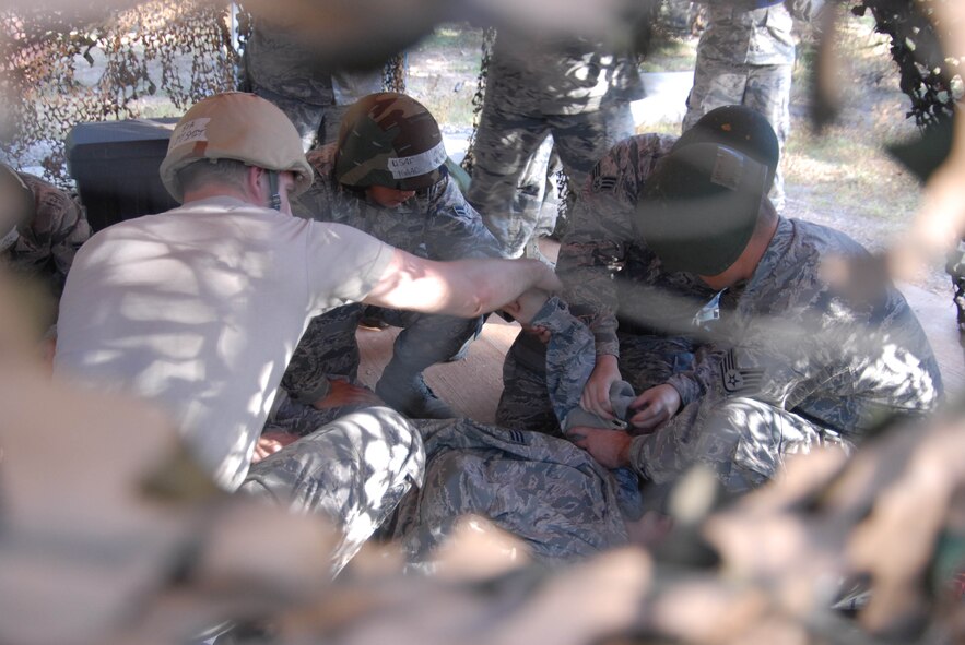 U.S. Airmen from the 15th Wing 747 Communications Squadron perform Self Aid Buddy Care (SABC) during a Chemical Biological Radiological Nuclear (CBRN) exercise at Joint Base Pearl Harbor-Hickam, Hawaii, Feb. 5, 2015. The exercise is part of the Commanders Inspection Program (CCIP) which includes objectives that evaluate SABC capabilities in a CBRN working environment. (U.S. Air National Guard photo by A1C Robert Cabuco)
