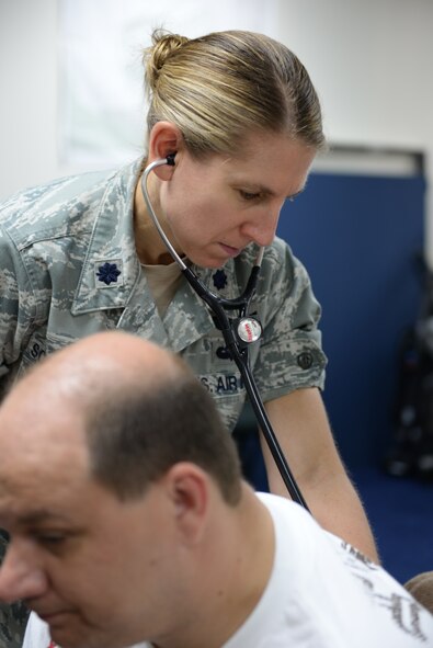 U.S. Air Force Lt. Col. Kristen Soltis-Tyler evaluates Tech. Sgt. Robert Hauck in the 506th Expeditionary Air Refueling Squadron Operations building, Andersen AFB, Guam, on Jan. 22, 2015. Soltis-Tyler is deployed as the flight doctor from the 64th Air Refueling Squadron, Pease Air National Guard Base, N.H., to the 506 EARS. (U.S. Air National Guard photo by Senior Airman Kayla McWalter/RELEASED)