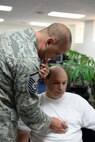 U.S. Air Force Master Sgt. Shawn Theberge evaluates Tech. Sgt. Robert Hauck in the 506th Expeditionary Air Refueling Squadron Operations building, Andersen AFB, Guam, on Jan. 22, 2015. Theberge is deployed as a Medical Technician from the 157th Air Refueling Wing, N.H., to the 506 EARS. (U.S. Air National Guard photo by Senior Airman Kayla McWalter/RELEASED)