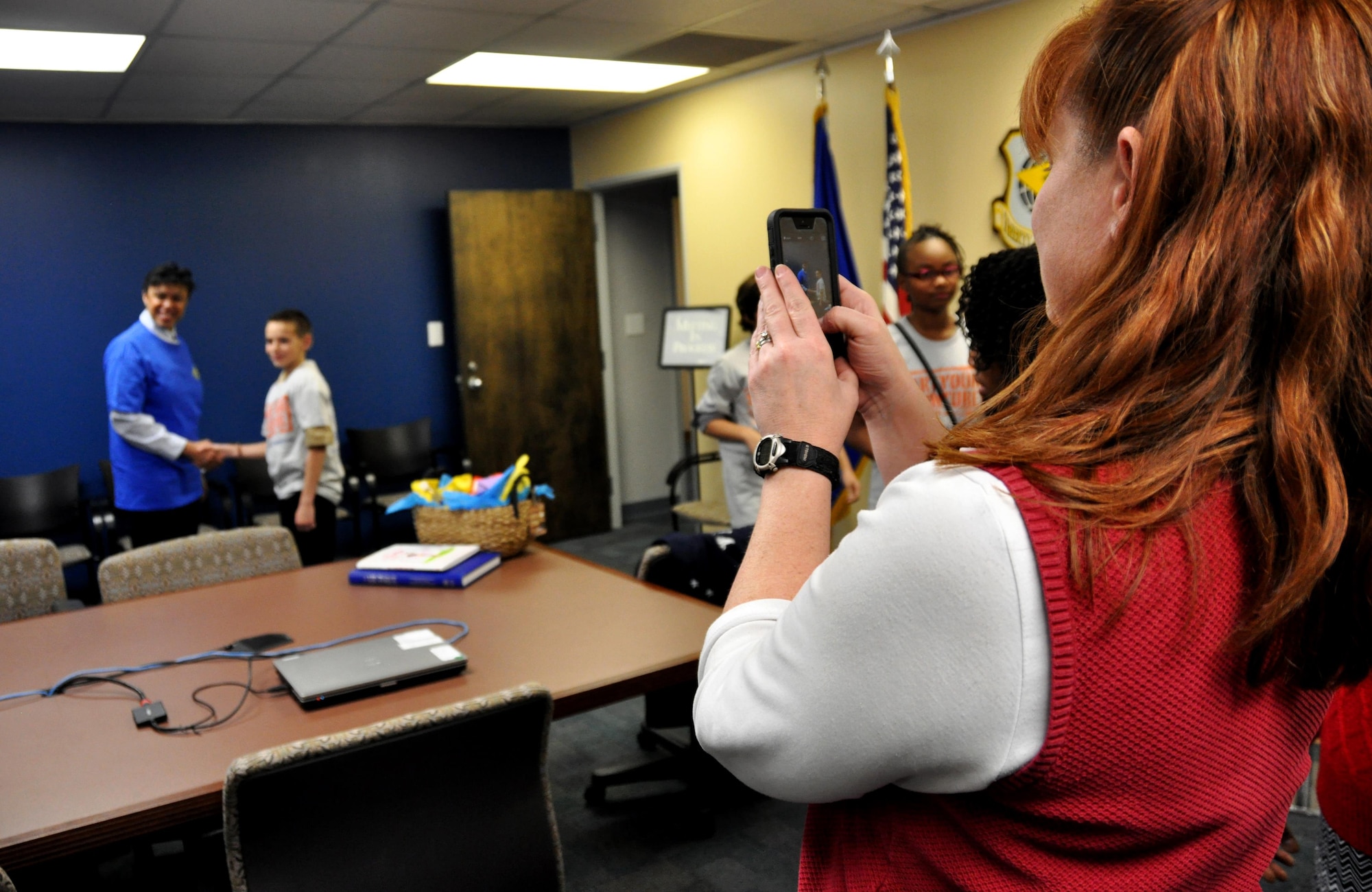 Tammy Moyse, a parent of a Bright Star Elementary student, takes a photo of her son Dalton with Maj. Gen. Stayce Harris, 22nd Air Force commander, at the 22nd AF headquarters at Dobbins Air Reserve Base, Ga., Feb. 7, 2015. Ten students from Bright Star visited the installation to interview Harris for Black History month. (U.S. Air Force photo/Senior Airman Daniel Phelps)