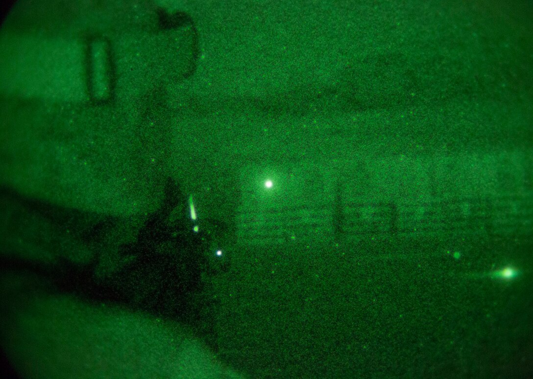 Cpl. Clinton E. Ransom uses his PVS-14 night vision device to see an infrared light marking his target Jan. 23 to fire table three bravo (rifle course) at Marine Air Ground Combat Center Twentynine Palms, as part of Integrated Training Exercise 2-15. Table three emphasizes combat marksmanship to hone Marines’ skills as riflemen. Table three bravo is the same course of fire as table three alpha, except it is at night with night vision gear. Ransom, a Clovis, New Mexico, native, is a motor vehicle operator with 4th Marine Regiment, 3rd Marine Division, III Marine Expeditionary Force.