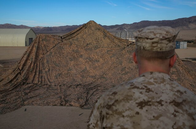 Sgt. Randall W. Lester guides junior Marines setting up the combat operations center Jan. 16, at Marine Air Ground Combat Center Twentynine Palms, for Integrated Training Exercise 2-15. Lester stood back to make sure the netting was placed in the correct location to fit all of the tents for the COC. The COC is where the command element monitors units and is a decision making hub. Lester, a Phoenix, Arizona, native, is an assistant fires chief for 4th Marine Regiment, 3rd Marine Division, III Marine Expeditionary Force. 