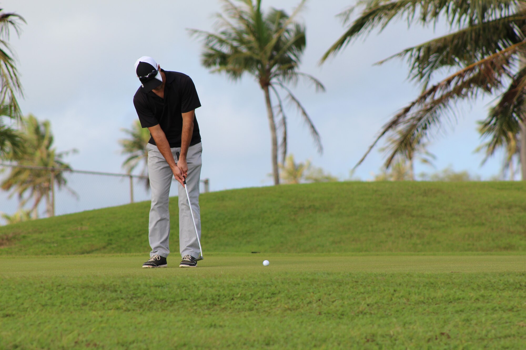 Team Andersen member makes a put in a tournament Jan.31, 2015, on Andersen Air Force Base’s Palm Tree Golf Course. About 60 golfers participated in the tournament and enjoyed the upgraded amenities of the new golf pro shop and its location. (U.S. Air Force photo by 1st Lt. Jessica Clark/Released)