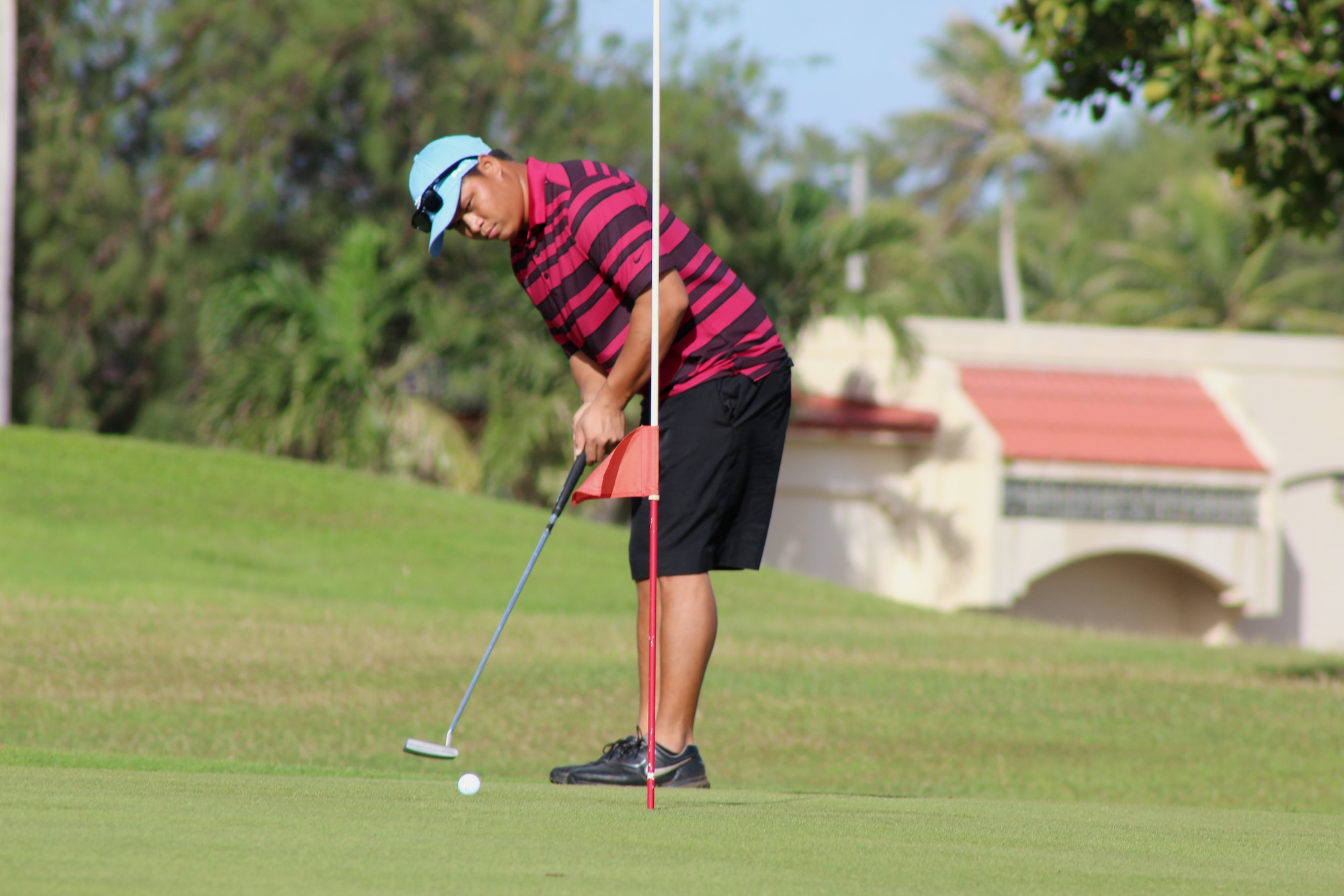 A Team Andersen golfer focuses on his put Jan. 31, 2015, during a tournament on Andersen Air Force Base, Guam. About 60 golfers participated in a tournament and enjoyed the upgraded amenities of the new golf pro shop and its location. (U.S. Air Force photo by 1st Lt. Jessica Clark/Released) 