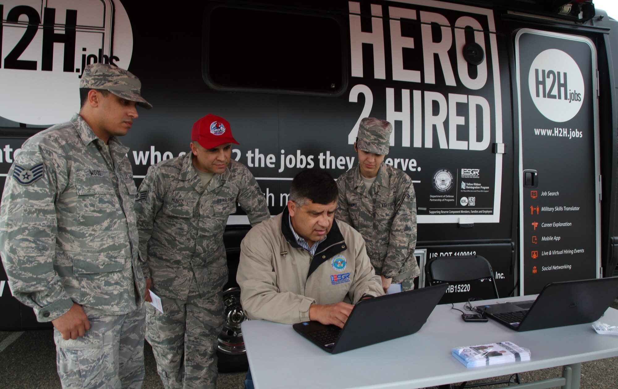 Art Alvarez, an Employer Support of the Guard and Reserve representative, helps 940th Wing Reservists search for employment at the Hero 2 Hired van during the February Unit Training Assembly, Feb. 7, Beale Air Force Base, Calif.  H2H also offers job matching, education services, counseling and vocational resources. (U.S. Air Force photo by Tech. Sgt. Kenneth McCann/Released)