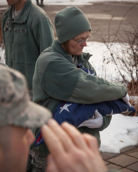 Master Sgt. Mary Miller, 934th Airlift Wing, smooths the flag as she finishes folding it during the retreat ceremony Saturday of the Unit Training Assembly weekend at the Minneapolis-St. Paul Air Reserve Station, Minn.  (U.S. Air Force photo by Shannon McKay/Released)