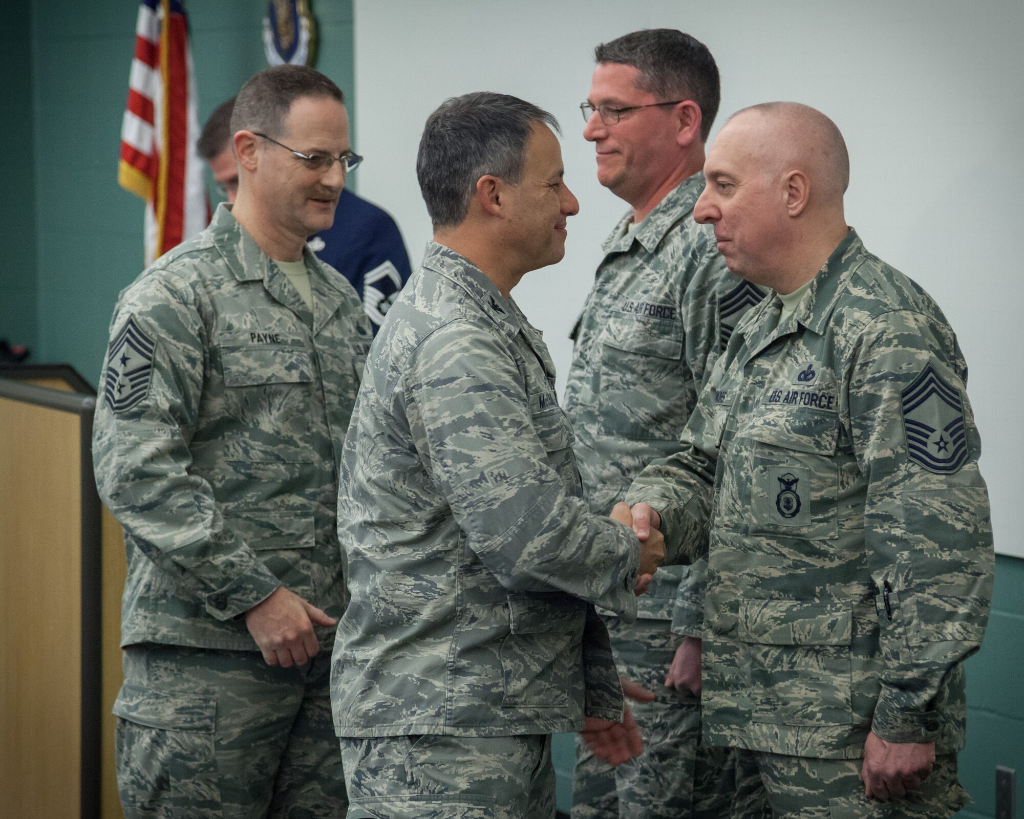 Col. Todd McCubbin (front), 934th Airlift Wing commander, and Chief Master Sgt. Bryan Payne, 934 AW command chief, congratulate the wing's newest Chief Master Sgts., Barry Haukoos (far right), 934th Security Forces Squadron, and Richard Mathies, 934th Maintenance Group.  Newly promoted 934th Airlift Wing Non-Commissioned Officers were recognized in a ceremony Saturday at the Minneapolis-St. Paul Air Reserve Station, Minn. (U.S. Air Force photo by Shannon McKay/Released)