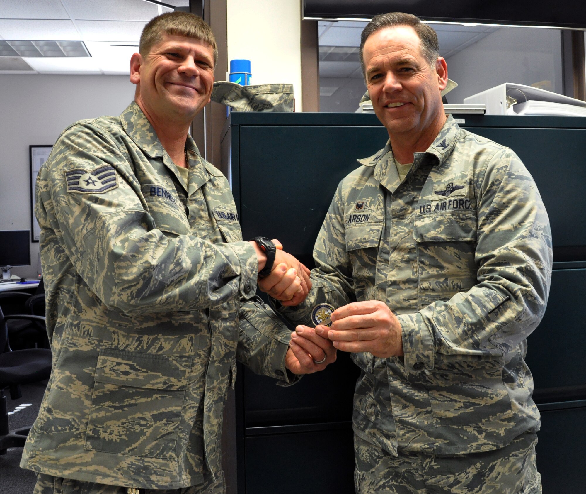 February Spotlight Performer! Col. Mark S. Larson, 931st Air Refueling Group commander, presents a commander’s coin to Staff Sgt. Bruce Bennet, 931st Civil Engineer Squadron during the February Unit Training Assembly at McConnell Air Force Base, Kan., Feb. 8, 2015. Bruce was recognized as the 931 ARG’s “Spotlight Performer” for the month based on his outstanding performance and accomplishments, including his assistance in helping fellow Airmen achieve skill level upgrades, his work in developing Total Force Initiatives, and completing a high number of backlogged projects for AFRC buildings, as well as strengthening procedures and practices throughout the CES. (U.S. Air Force photo by Capt. Zach Anderson)
