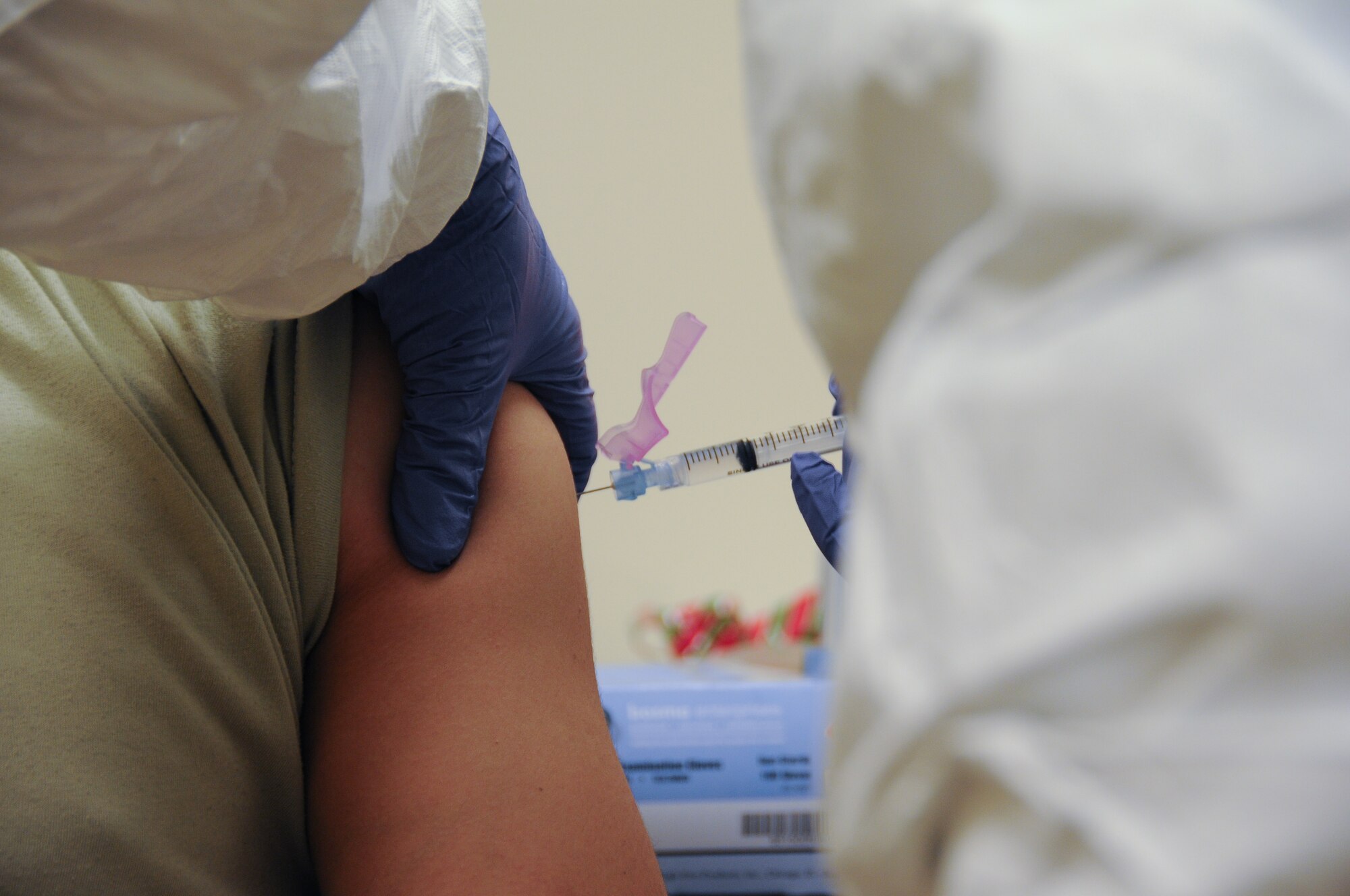 A picture of U.S. Air Force Senior Airman Jennifer Heller giving a shot during the base's Disease Containment Exercise.