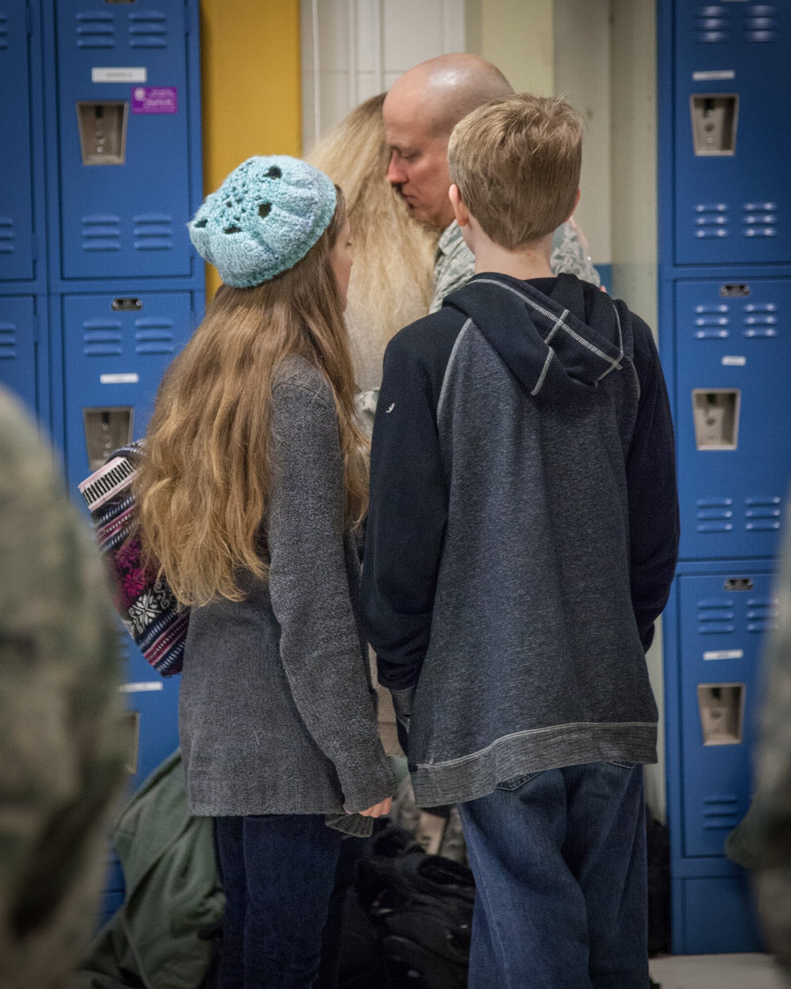 Master Sgt. Eric Amidon, 27th Aerial Port Squadron, embraces his family at a farewell ceremony before he deploys for the coming months.  Airmen from the 27 APS said goodbye to family, friends, and fellow Airmen as they departed for the airport February 7, heading to Southwest Asia.  (U.S. Air Force photo by Shannon McKay/Released)