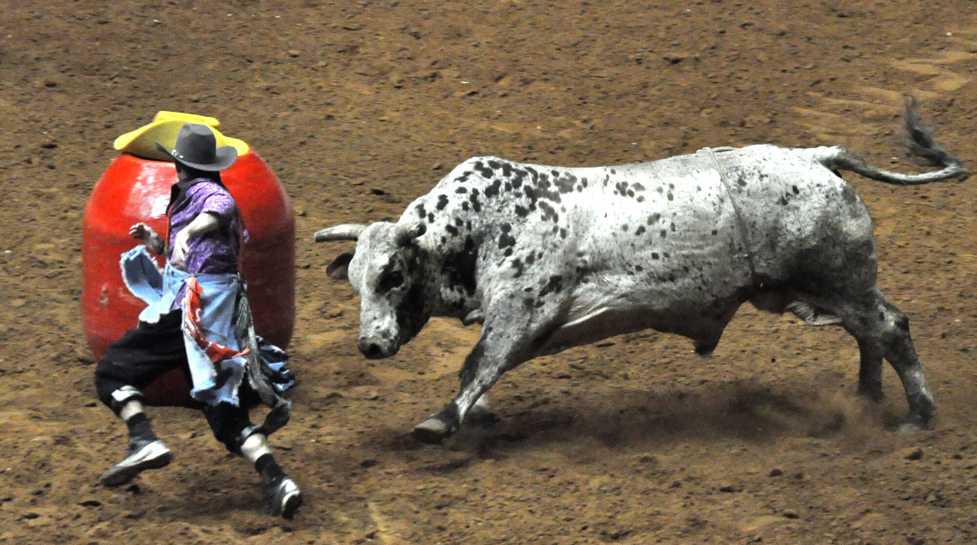 Rodeo clowns distract the bull Feb. 2 at the Fort Worth Stock Show and Rodeo in Fort Worth, Texas. The rodeo is a 23-day show, featuring seven specialty rodeos and 1,200 professional cowboy and cowgirl athletes competing for championship titles. (U.S. Air Force photo/Master Sgt. Julie Briden-Garcia)