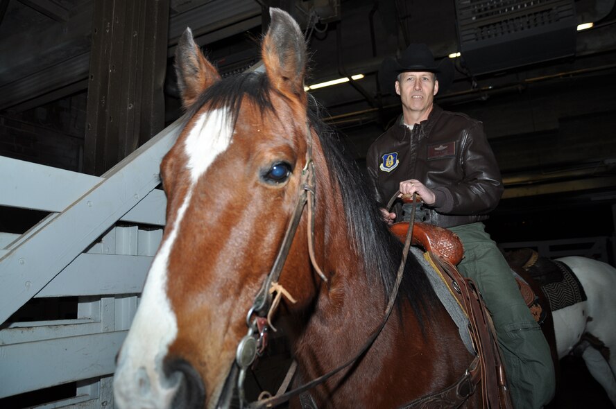 Col. Kevin Zeller, 301st Operations Group commander, adjusts to his new mode of transportation before riding in the 119th Annual Fort Worth Stock Show and Rodeo's grand entry Feb. 2 in Fort Worth, Texas. This Military Appreciation Day marks the ninth year the Fort Worth Stock Show and Rodeo has honored veterans and their families. (U.S. Air Force photo/Master Sgt. Julie Briden-Garcia)