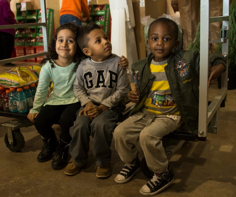 Children take a seat while waiting to check out at the registers at the commissary’s case lot sale on Duke Field, Fla., Feb. 6.  Patrons waited in line for at least 30 minutes to receive the special sales prices. The case lot sale was open to military, retirees, and their family members. (U.S. Air Force photo/Tech. Sgt. Cheryl L. Foster)