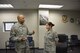 Command Sgt. Maj. William Clark Jr., State Senior Enlisted Advisor for the California National Guard, presents a coin to Staff Sgt. Micaelah Aleman, Airman and NCO council chairman, during his visit to the 144th Fighter Wing Feb. 7. (Air National Guard photo by Tech. Sgt. Charles Vaughn)