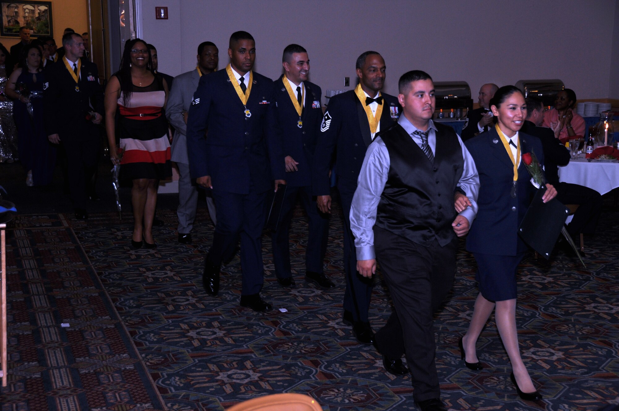 A parade of 433rd Airlift Wing's best Airmen and their guests enter the dining room of the Gateway Club, Feb. 8, 2015, after a medallion presentation during  the Fourth Annual Awards Banquet. 

More than 300 Airmen, honorary commanders, family members and guests attended the event, hosted by the First Sergeants Council at Joint Base San Antonio-Lackland, Texas. (U.S. Air Force by Tech. Sgt. Carlos J. Trevino)
