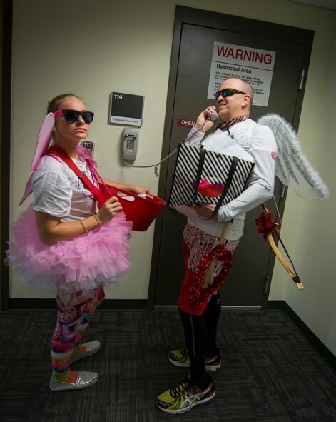 Senior Airman Bianca Trevathan and Senior Master Sgt. Randy Merritt, 919th Special Operations Wing, dressed up as Cupid to help pass out candy grams Feb. 8 at Duke Field, Fla.  The proceeds benefit the Senior Airman Josh Santos Memorial. More than 100 people participated. (U.S. Air Force photo/Tech. Sgt. Jasmin Taylor)