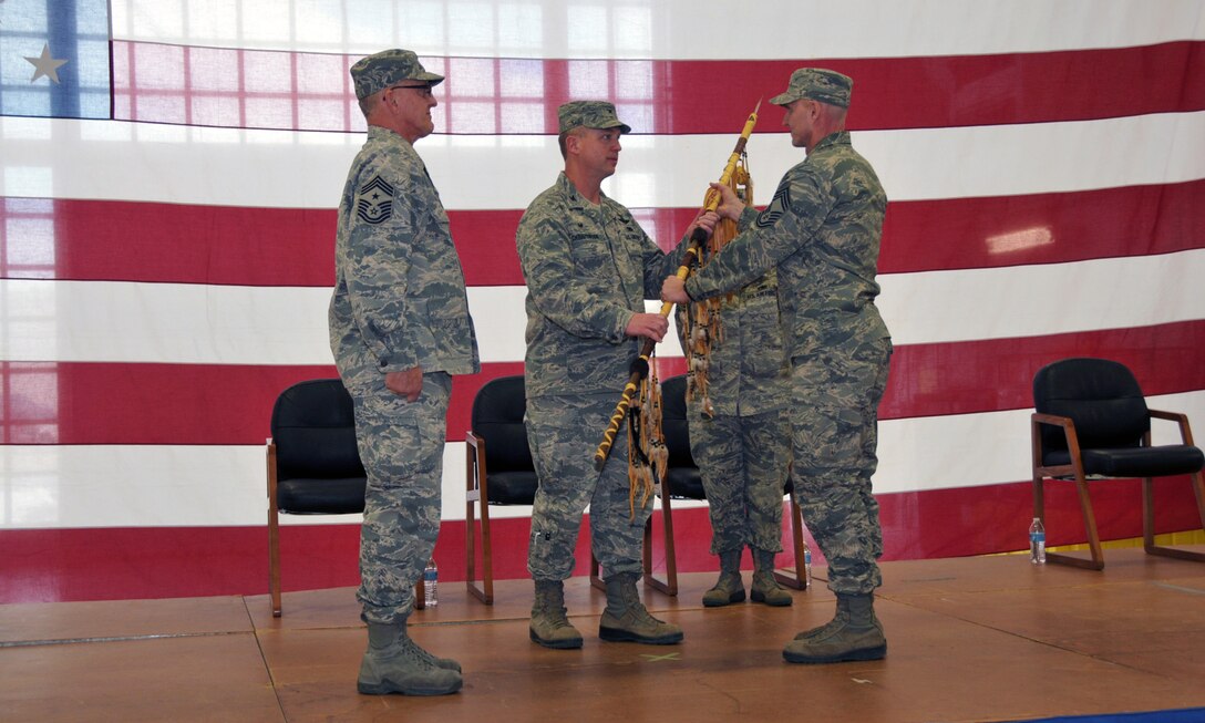 Col. Lawrence Christensen, 185 Air Refueling Wing Commander, passes the ceremonial spear to the new Wing Command Chief Master Sgt. Phillip Frank at a Change of Authority ceremony held at the Air National Guard base in Sioux City, IA onFebruary 7, 2015. Frank was chosen to become the unit’s sixth Command Chief Master Sgt. due to the impending retirement of former Wing Command Chief Master Sgt. Dave Miller. (U.S. Air National Guard photo by Tech. Sgt. Bill Wiseman/Released)