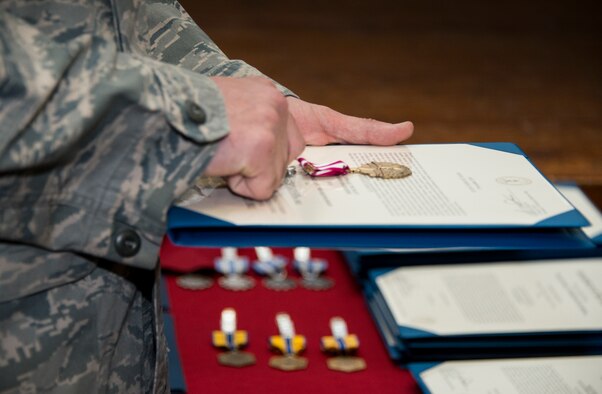 A 919th Special Operations Maintenance Group proffer holds a medal to be presented during the group’s commander’s call Feb. 7 at Duke Field, Fla.  Approximately 10 medals were presented to maintenance Airmen during the call.  (U.S. Air Force photo/Tech. Sgt. Cheryl Foster)