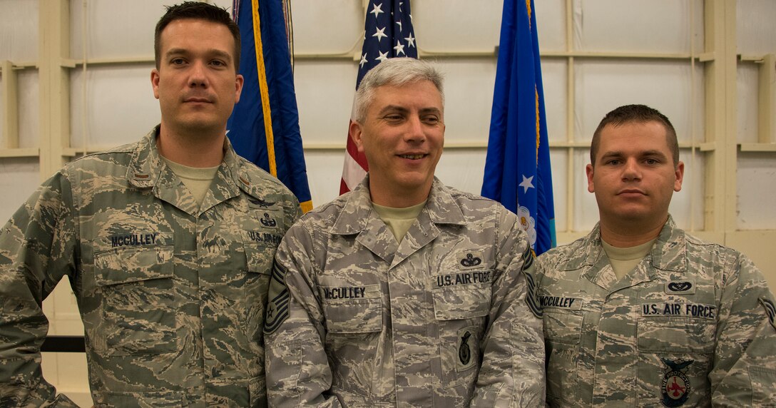 2nd Lt. Scott McCulley, Chief Master Sgt. Ronald McCulley and Senior Airman Douglas McCulley are members of the 919th Special Operations Wing.  The lieutenant administered the oath of enlistment to his brother, the chief, during a recent commander’s call.  The chief’s son, was there to witness the family event. (U.S. Air Force photo/Tech. Sgt. Cheryl Foster) 