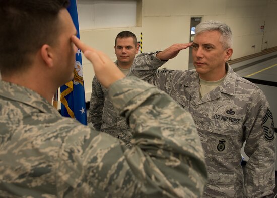 Chief Master Sgt. Ronald McCulley, salutes his younger brother, 2nd Lt. Scott McCulley, after his reenlistment ceremony in December.  McCulley, his brother and son, Senior Airman Douglas McCulley (pictured), are all members of the 919th Special Operations Wing.  The lieutenant administered the oath of enlistment to his brother in front of many of the wing’s Airmen during a unit task assembly commander’s call.  (U.S. Air Force photo/Tech. Sgt. Cheryl Foster)