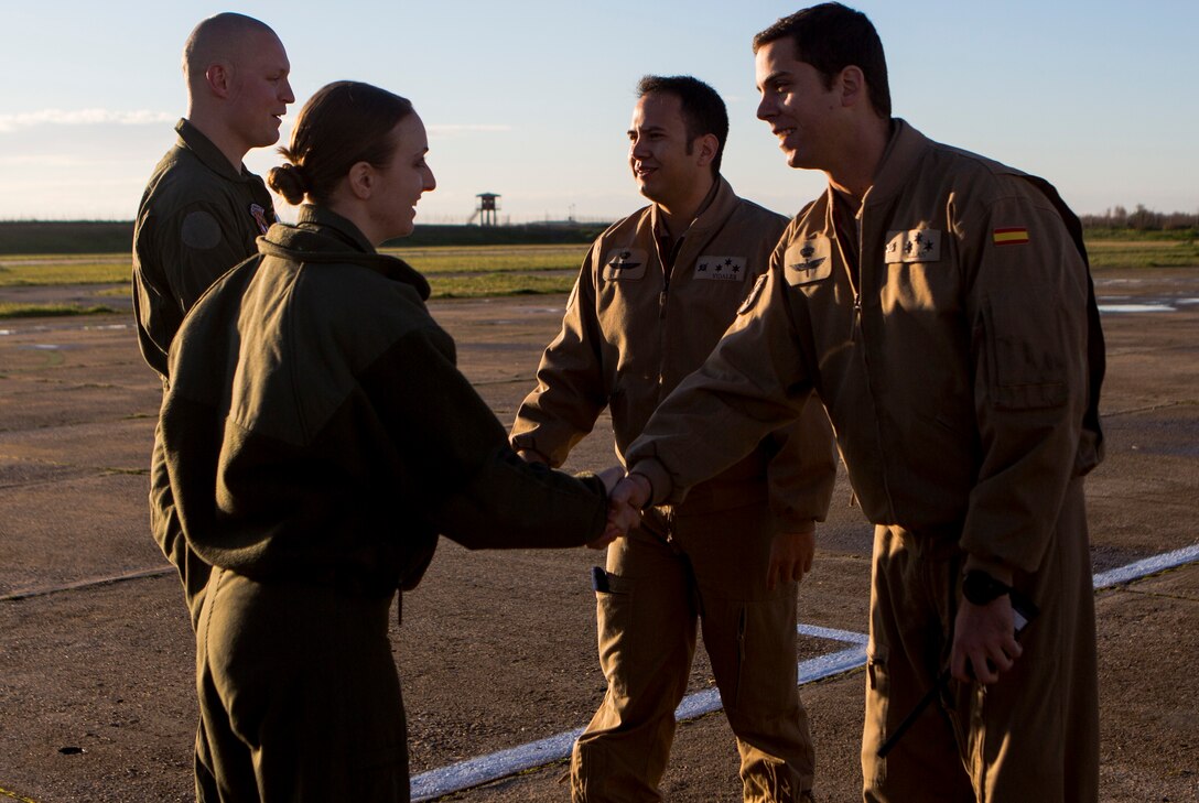 U.S. Marine Corps Capt. Sarah Smith, left, an MV-22 Osprey pilot with Special-Purpose Marine Air-Ground Task Force Crisis Response-Africa, shakes hands with Spanish Army Capt. Rafael Illan, a pilot with Bhelma IV, before conducting a bi-lateral training exercise near Sevilla, Spain, Feb. 4, 2015 . Spanish and American pilots flew inside the same aircraft to gain a better understanding of their different flight operations and further improve the working relationships between the two NATO forces . (U.S. Marine Corps photograph by Lance Cpl. Christopher Mendoza/Released)