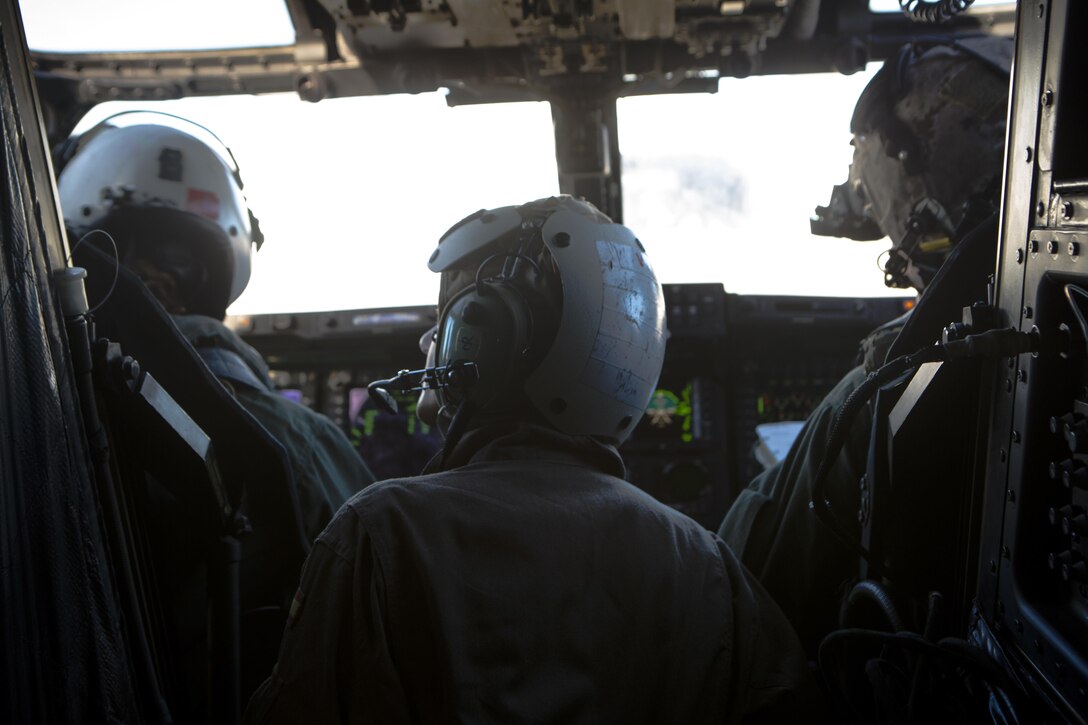 Spanish Army Maj. Gala Gallego, center, a pilot with Bhelma IV, observes a pre-flight check inside an MV-22 Osprey while conducting a bi-lateral training exercise with Special-Purpose Marine Air-Ground Task Force Crisis Response-Africa near Sevilla, Spain, Feb. 4, 2015. Operating as an integrated group gives insight on the different forces’ procedures and capabilities, forging the bonds necessary to complete future operations as a unified team.  (U.S. Marine Corps photograph by Lance Cpl. Christopher Mendoza/Released)