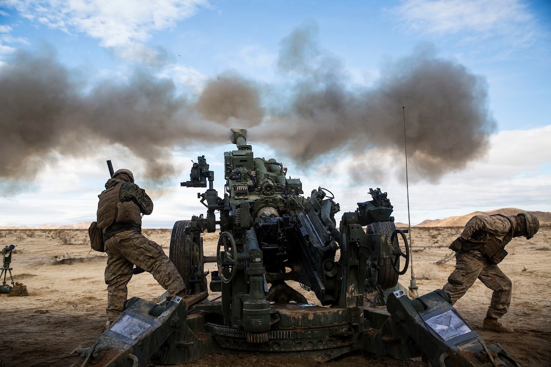 Lance Cpl. Christian J. Hernandez (left) and Lance Cpl. Giovonni Mejia fire the M777A2 lightweight 155 mm howitzer Jan. 31 to support units engaged in the mechanized assault course at Marine Air Ground Combat Center Twentynine Palms during Integrated Training Exercise 2-15. “Fighting with combined arms is on of the most important parts of the (Marine Air-Ground Task Force),” said Lt. Col. Neil J. Owens. Giovonni, a Dallas, Texas native and Hernandez, a Buford, Georgia, native are both cannoneers with 1st Battalion, 12th Marine Regiment, currently assigned to 3rd Battalion, 12th Marines, 3rd Marine Division, III Marine Expeditionary Force for ITX 2-15, as part of the ground combat element for SPMAGTF-4. Owens, a Medford, Massechusetts, native, is the commanding officer for 3rd Bn., 12th Marines. 