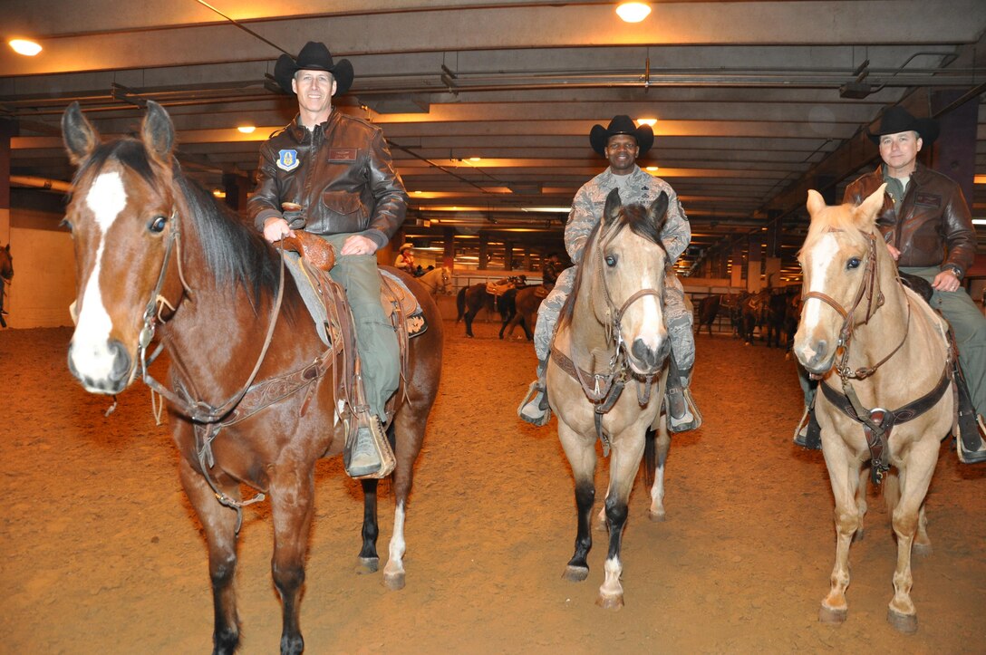 Col. Kevin Zeller, 301st Operations Group commander, Col. John Breazeale, 301st Fighter Wing commander, and Chief Master Sgt. Terry Goines, 301st Fighter Wing command chief, take a few moments to warm up their horses before riding Feb. 2 in the Fort Worth Stock Show and Rodeo's grand entry. This year's Military Appreciation Day marks the ninth year the Fort Worth Stock Show and Rodeo has honored veterans and their families. (U.S. Air Force photo/Master Sgt. Julie Briden-Garcia)