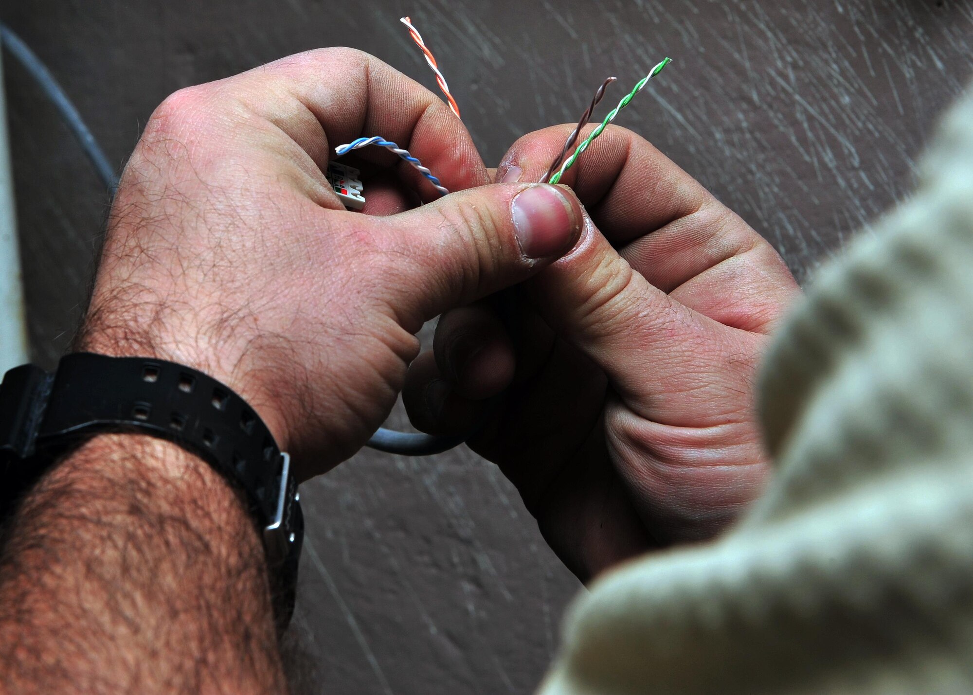 U.S. Air Force Staff Sgt. Bryant Horton, 85th Engineering and Installation Squadron cable and antenna technician, terminates cables in preparation for use as part of a rewiring project Jan. 28, 2015 at Bagram Airfield, Afghanistan. The project, scheduled to take 100 days to complete, will ensure Emissions Security requirements are upheld and prevent secure information from being leaked through emanation. (U.S. Air Force photo by Staff Sgt. Whitney Amstutz/released)