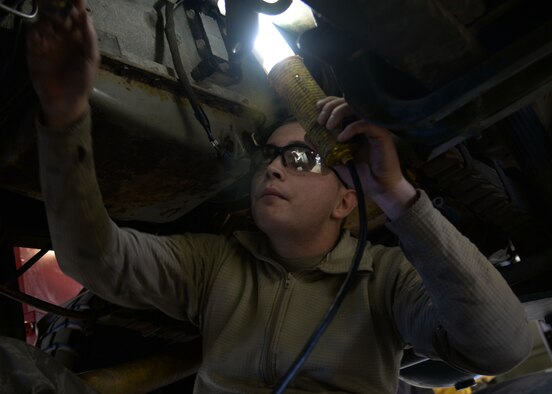 Senior Airman Lloyd Carlyle, 27th Special Operations Logistics Readiness Squadron fire truck mechanic, works on an out-of-service M35 fire truck Feb. 5, 2015 at Cannon Air Force Base, N.M. The M35 is typically used at Melrose Air Force Range, N.M., to combat brush fires. (U.S. Air Force photo/Staff Sgt. Alexxis Mercer)