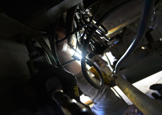 Senior Airman Lloyd Carlyle and Airman 1st Class Joshua Davis, 27th Special Operations Logistics Readiness Squadron fire truck mechanics, inspect components of an out-of-service M35 fire truck Feb. 5, 2015 at Cannon Air Force Base, N.M. The two are trouble-shooting several aspects of the non-operational vehicle needed by base fire fighters for emergency response. (U.S. Air Force photo/Staff Sgt. Alexxis Mercer)