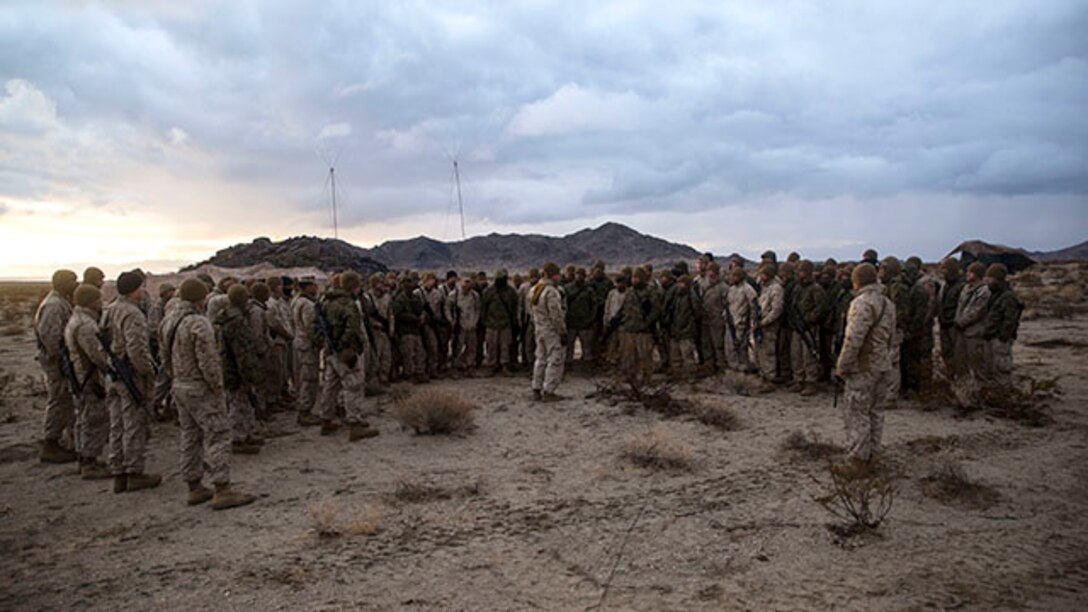 Marines gather around Capt. Justin E. Sumner Jan. 30 at Marine Air Ground Combat Center Twentynine Palms during Integrated Training Exercise 2-15 to debrief and discuss the following day’s mission. ITX 2-15 gives all elements of the Marine Air-Ground Task Force to operate in the field together. Sumner, a Mooresville, Indiana, native, is the battery commander. Sumner and the Marines are with Alpha Battery, 1st Battalion, 12th Marine Regiment currently assigned to 3rd Battalion, 12th Marines, 3rd Marine Division, III Marine Expeditionary Force for ITX 2-15 as a part of the ground combat element for Special Purpose Marine Air-Ground Task Force 4. (U.S. Marine Corps photo by Lance Cpl. William Hester/ Released)