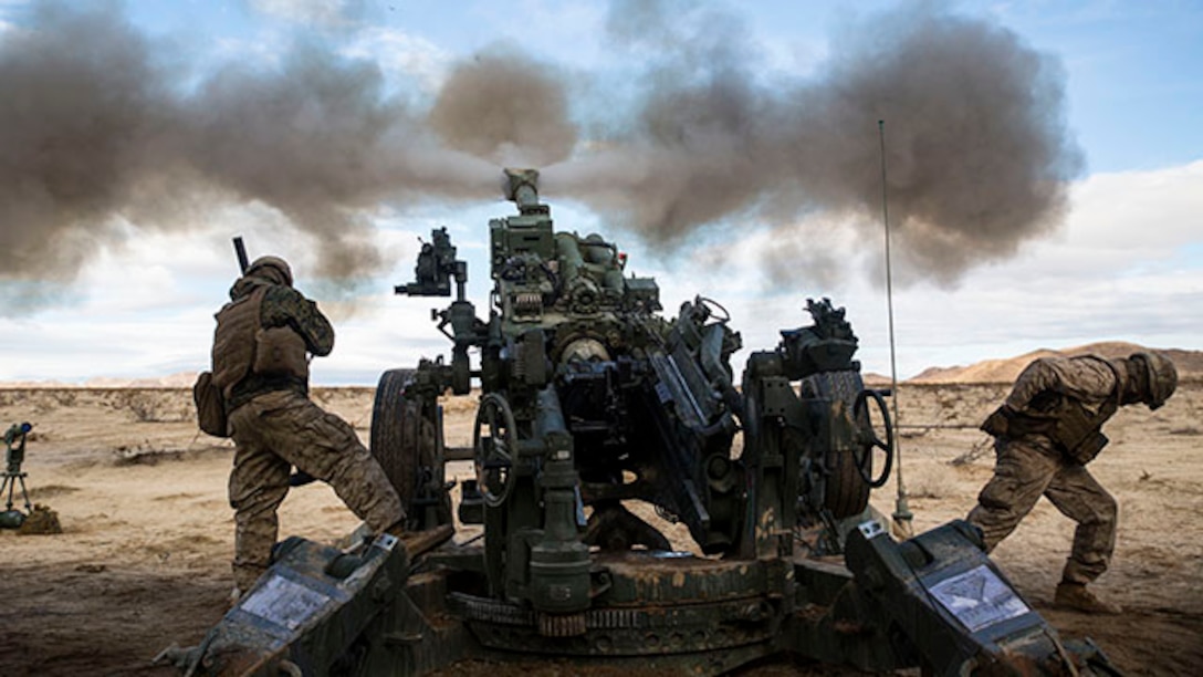 Lance Cpl. Christian J. Hernandez (left) and Lance Cpl. Giovonni Mejia fire the M777A2 lightweight 155 mm howitzer Jan. 31 to support units engaged in the mechanized assault course at Marine Air Ground Combat Center Twentynine Palms during Integrated Training Exercise 2-15. “Fighting with combined arms is on of the most important parts of the (Marine Air-Ground Task Force),” said Lt. Col. Neil J. Owens. Giovonni, a Dallas, Texas native and Hernandez, a Buford, Georgia, native are both cannoneers with 1st Battalion, 12th Marine Regiment, currently assigned to 3rd Battalion, 12th Marines, 3rd Marine Division, III Marine Expeditionary Force for ITX 2-15, as part of the ground combat element for SPMAGTF-4. Owens, a Medford, Massechusetts, native, is the commanding officer for 3rd Bn., 12th Marines. (U.S. Marine Corps photo by Lance Cpl. William Hester/ Released)