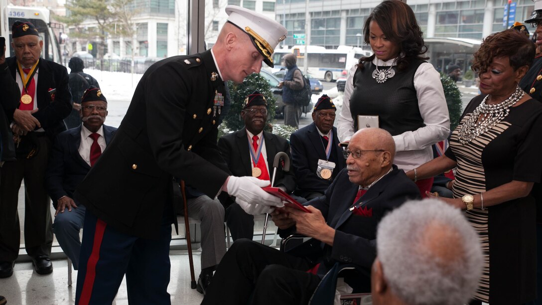 Hiram Knowles is presented a citation from the President of the United States, Barack Obama, during his award ceremony of receiving the Congressional Gold Medal. Knowles was one of over 400 Montford Point Marines to be awarded since 2012.